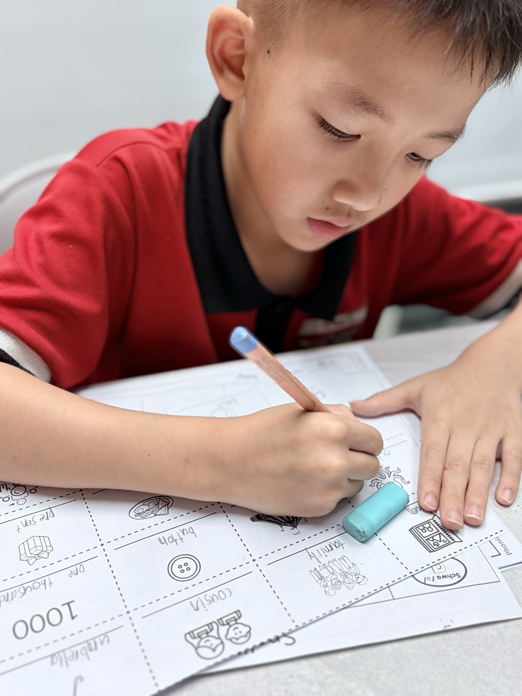 A pupil writing words during a spelling activity at Euphoria